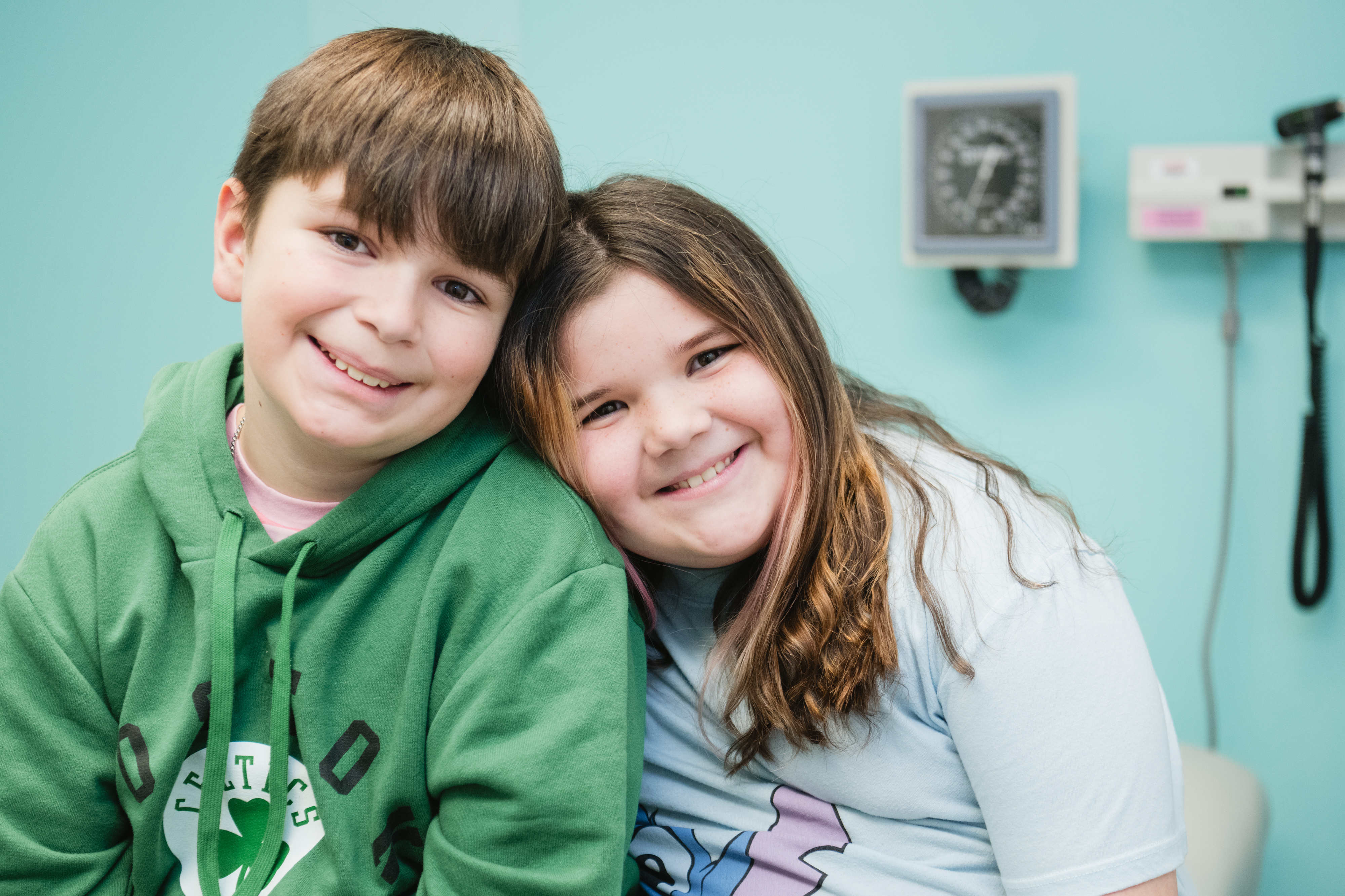 two children smiling in a doctor's office