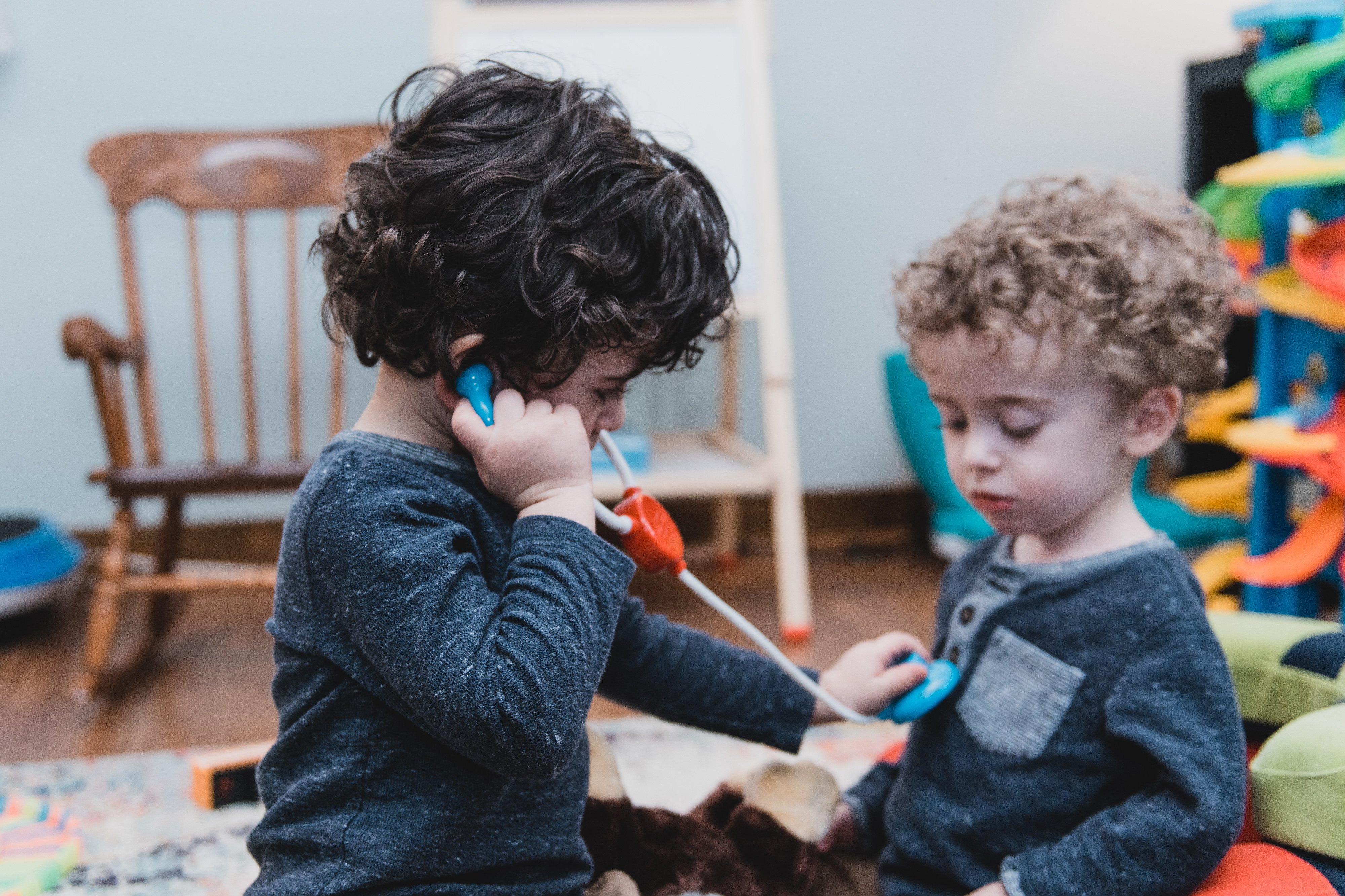Toddlers play with a stethoscope in their playroom at home. Toddlers play with a stethoscope in their playroom at home.