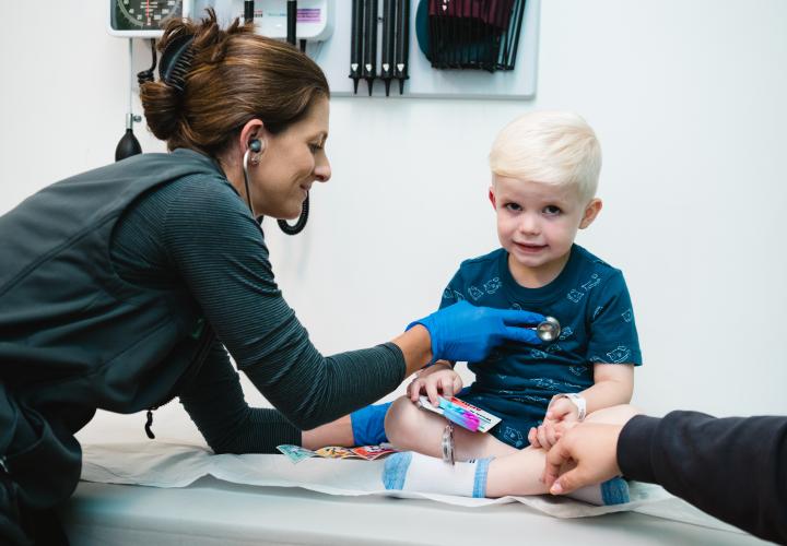 An Urgent Care patient is examined by an APRN. An Urgent Care patient is examined by an APRN.