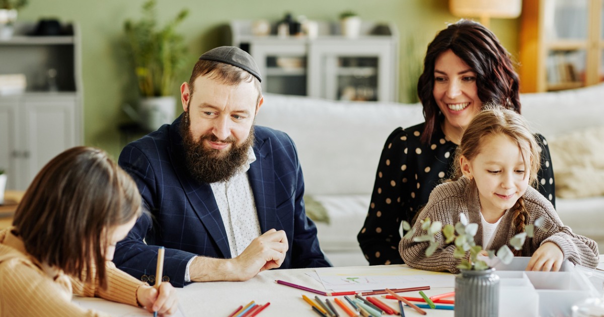 A Jewish family is having fun coloring with their kids