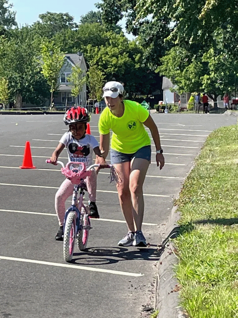 Girl getting help riding a bike