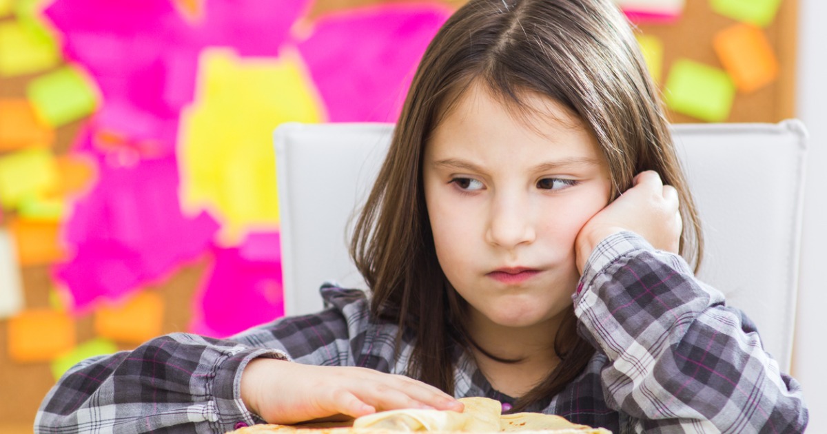 Young child indicating she's not hungry