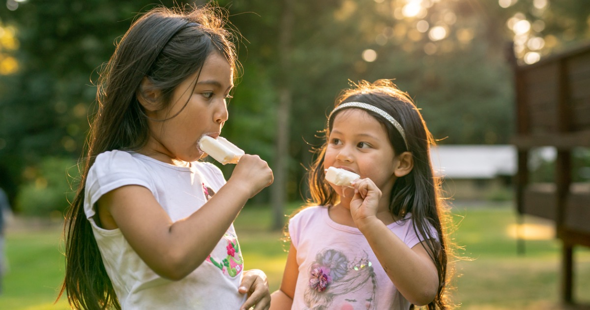 Sisters eating popsicles