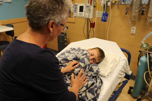 parent with child on bedside