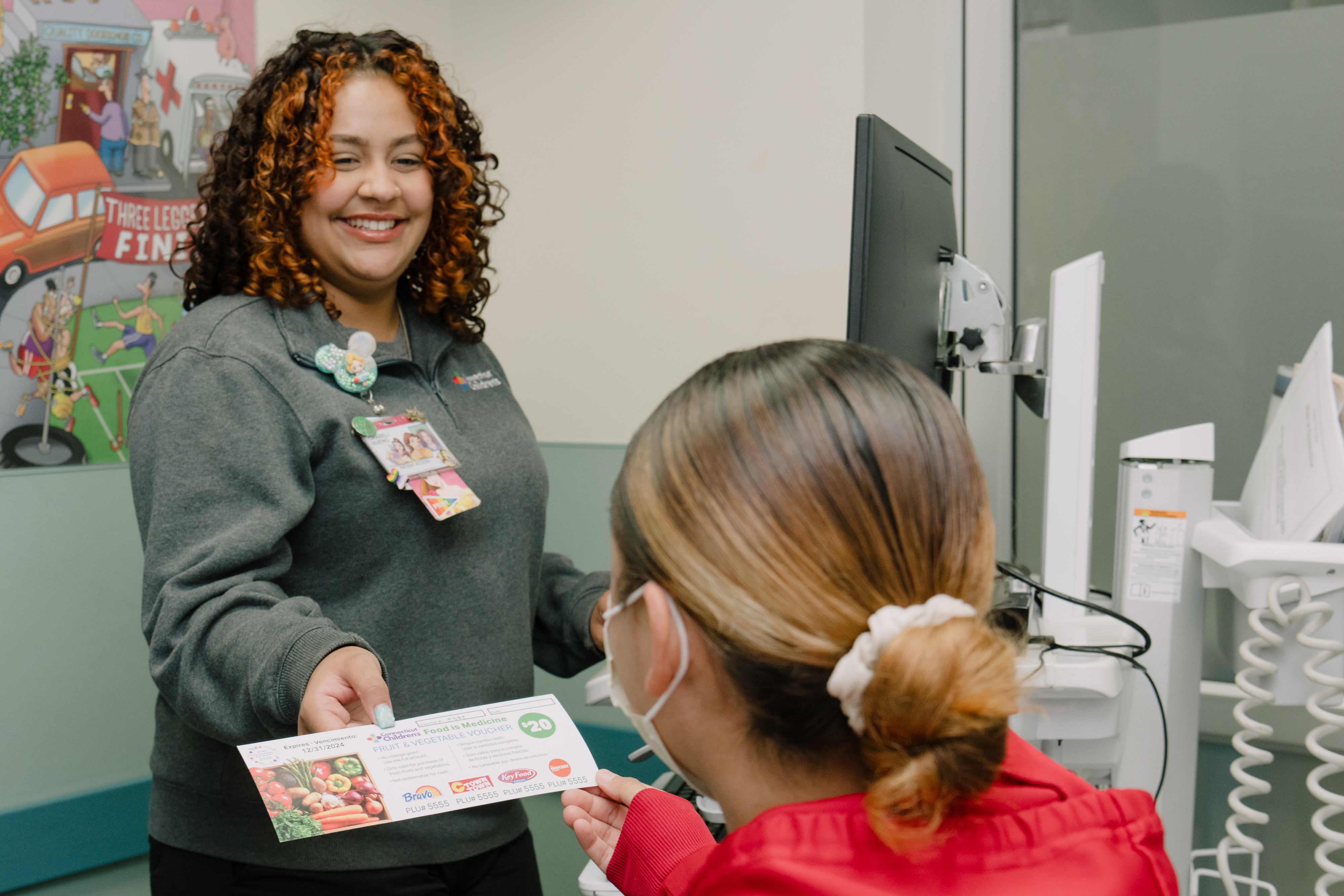 A patient being handed a food voucher in Connecticut Children's ED.