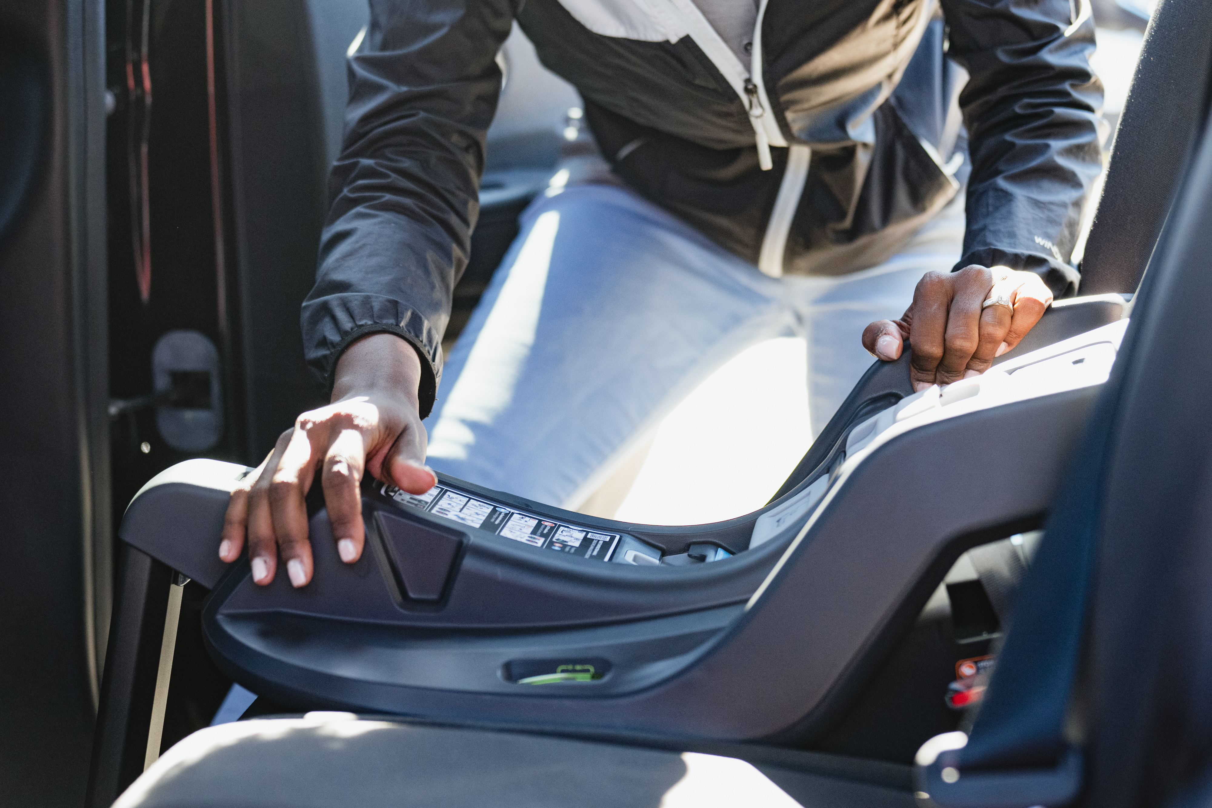 Car seat technician installing a car seat. 