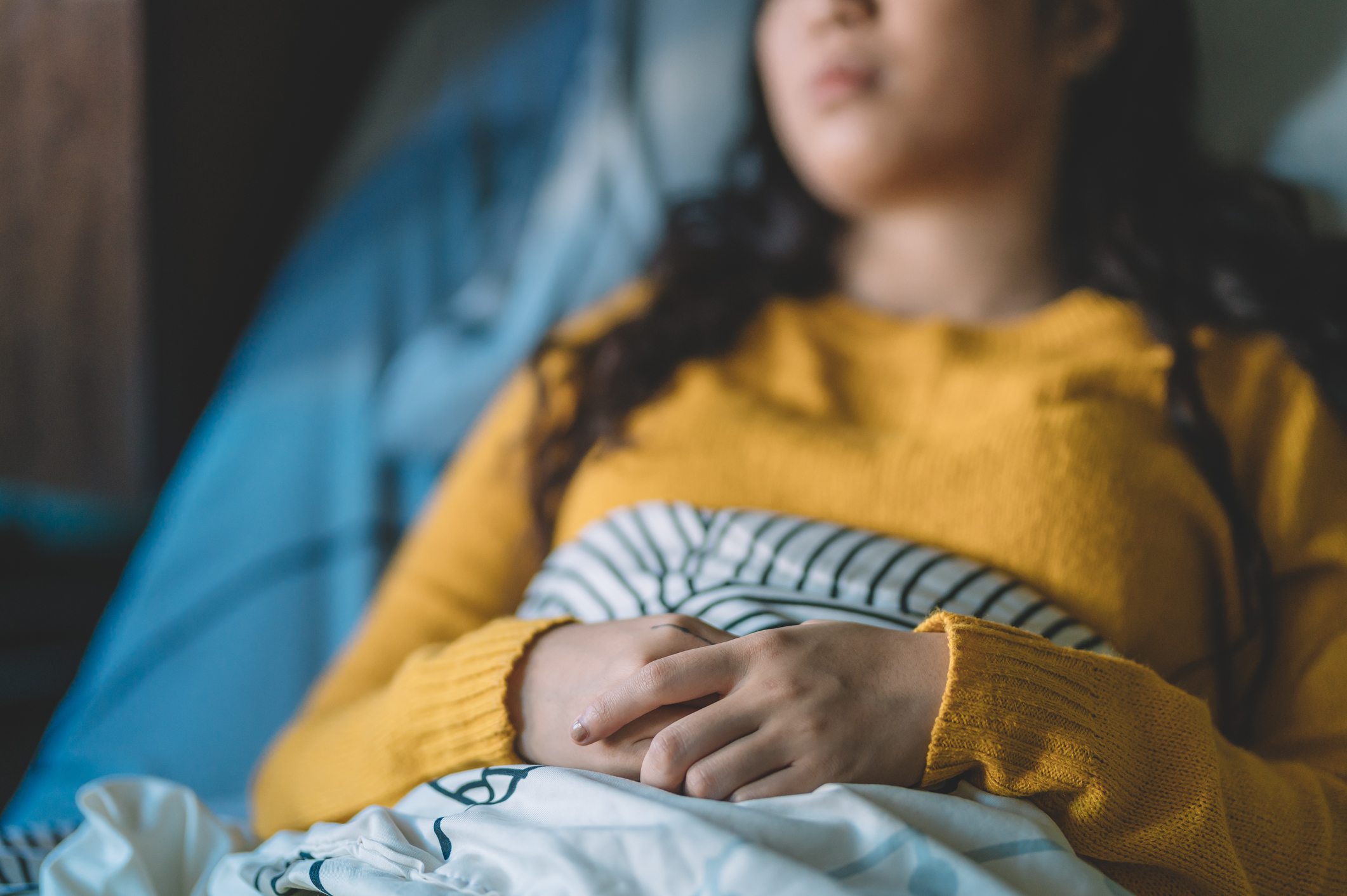 Teen laying in hospital bed