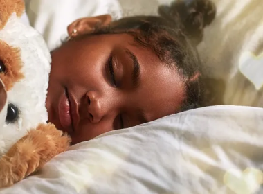 Girl sleeping with a teddy bear