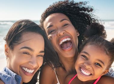 Family smiling on the beach