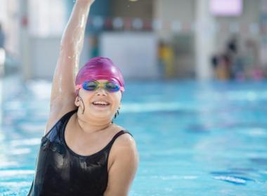 Young girl poses in the pool