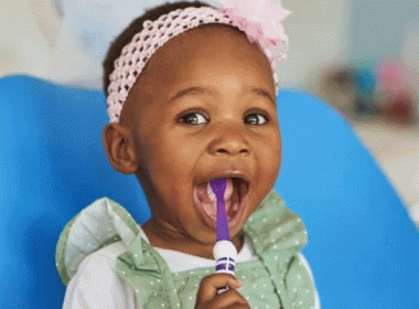 Girl with toothbrush in her mouth