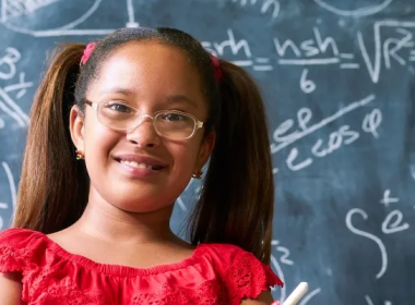 Girl in front of a chalkboard