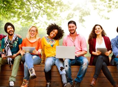 Adults sitting on wooden wall