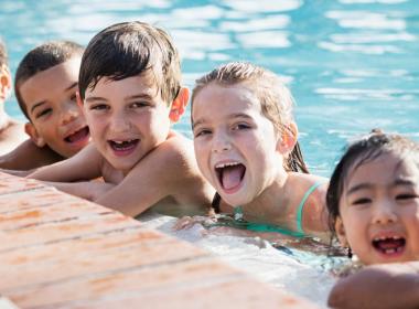 Young children playing in a pool