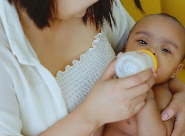 A mother giving her baby a bottle