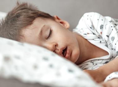 Young boy sleeping in bed