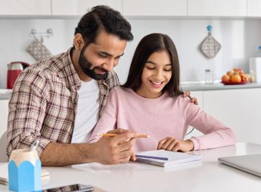 A father helping his daughter with homework