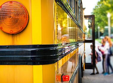 Kids getting on a school bus