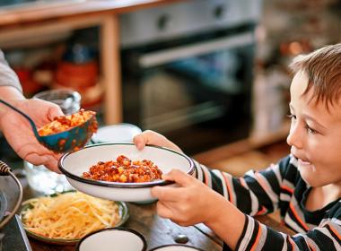 A child accepting a bowl of food