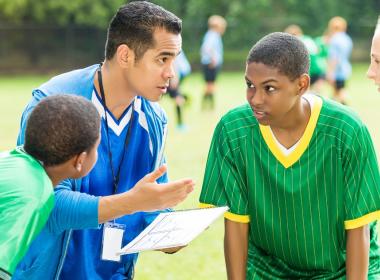 Coach talks to his players