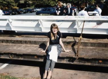 Woman sitting on concrete in front of steel beam for Newington Children's Hospital, circa 1996