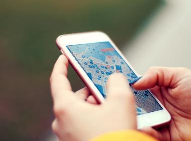 Person looking at a map on an iPhone. 