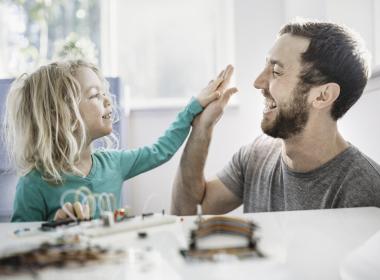 Father and son high fiving.