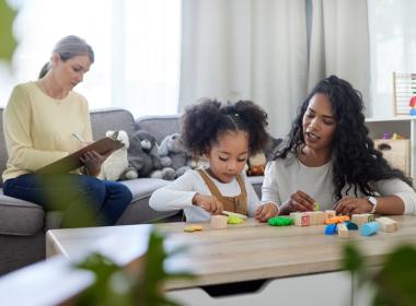 Therapist observing mom playing with young child