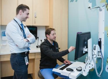 Two clinical team members looking at the computer screen