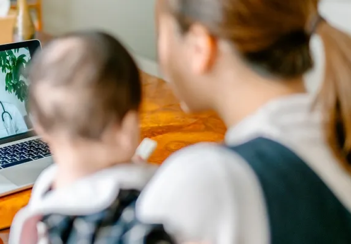 Mom and child looking at a computer screen