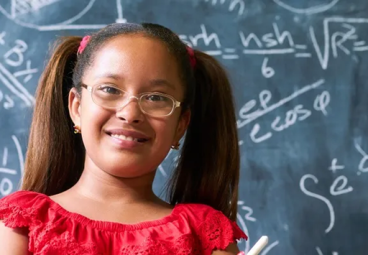 Girl in front of a chalkboard