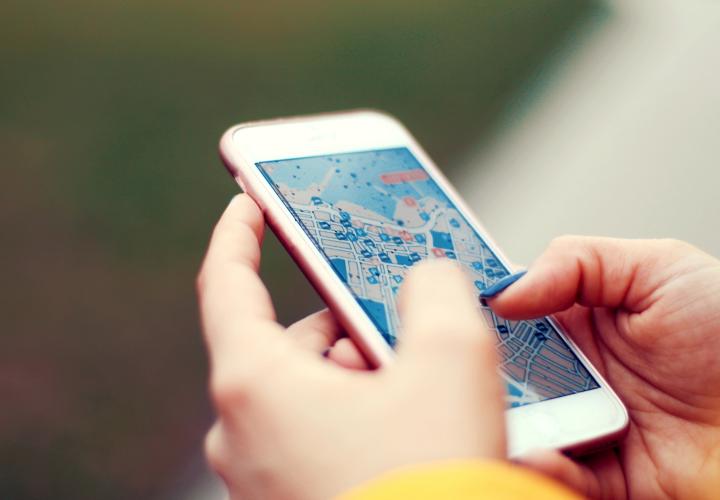 Person looking at a map on an iPhone. 