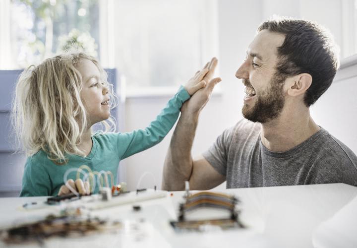 Father and son high fiving.