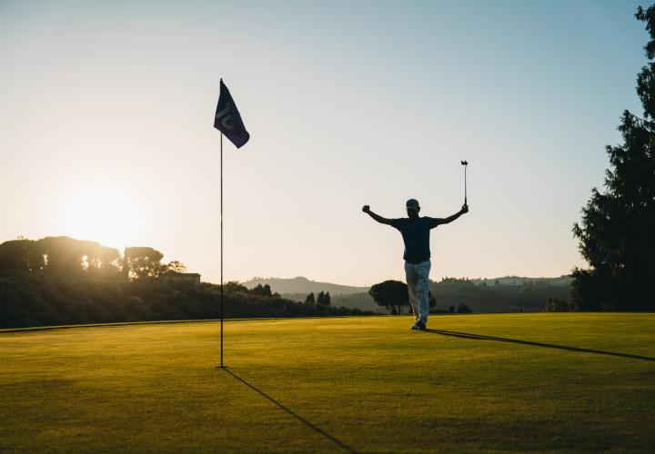 Person celebrating on a golf course