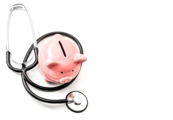 Piggy bank and a stethoscope. 