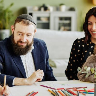 A Jewish family is having fun coloring with their kids