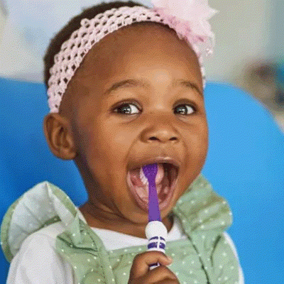 Girl with toothbrush in her mouth