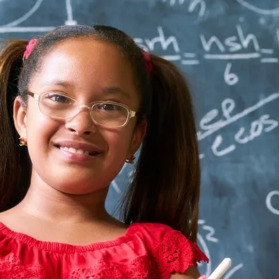 Girl in front of a chalkboard