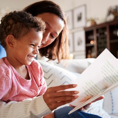 A mother reads a book with her son