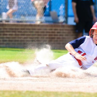 Boy sliding in baseball