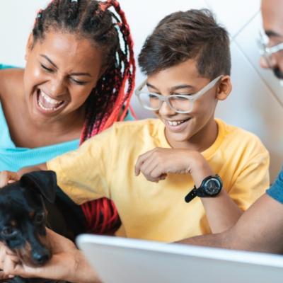 A family plays with their dog