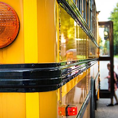 Kids getting on a school bus