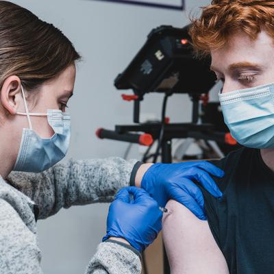 Teen getting a COVID vaccine