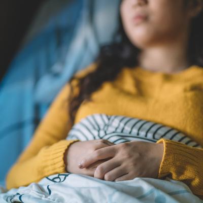 Teen laying in hospital bed