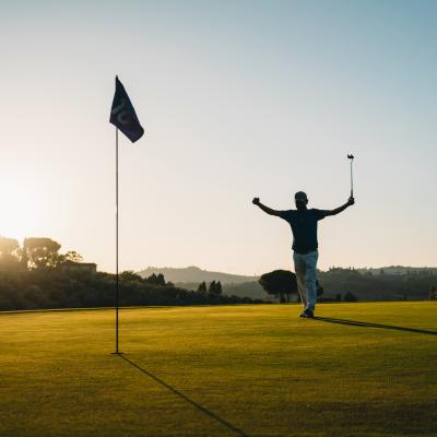 Person celebrating on a golf course