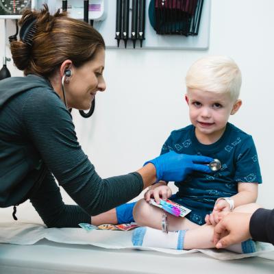 An Urgent Care patient is examined by an APRN. An Urgent Care patient is examined by an APRN.