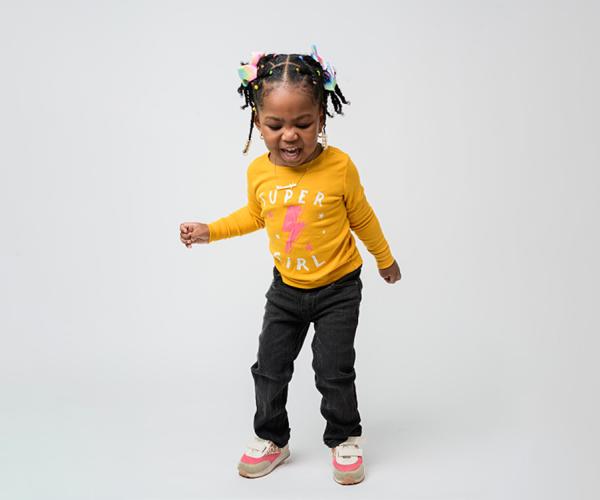 young child in bright yellow shirt