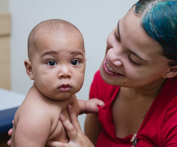 Mom smiling at baby in an exam room