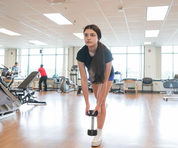 teenager doing exercises in the therapy gym